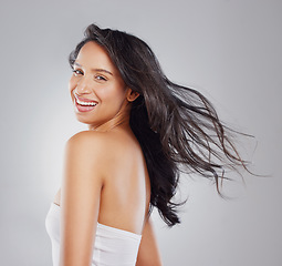 Image showing Healthy hair is every girls dream. Cropped portrait of an attractive young woman posing in studio against a grey background.