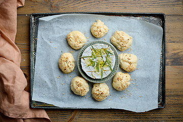 Image showing raw yeast dough buns and brie cheese