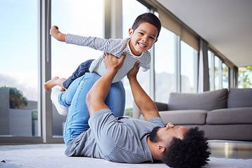 Image showing Every day is fun with dad. a young father playing with his son at home.