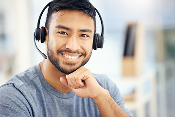 Image showing The best call center agent. a young male call center agent working in an office.