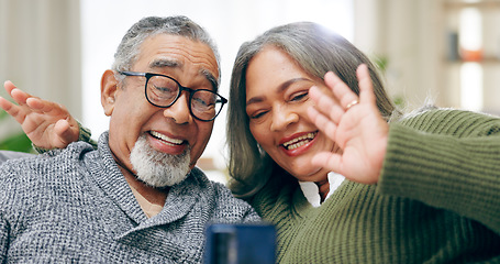 Image showing Senior couple, video call and phone on sofa with wave hello, smile and communication on web in home living room. Elderly lady, old man and happy for contact, live streaming and chat on social media