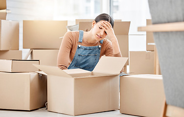 Image showing The uncertainty of what comes next is frightening to her. a young woman looking unhappy while moving house.