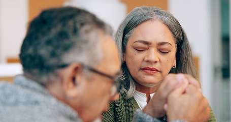 Image showing Hope, holding hands or old couple praying for support, trust or faith in marriage commitment at home. Eyes closed, wellness or senior man bonding with an elderly woman in prayer for peace or worship