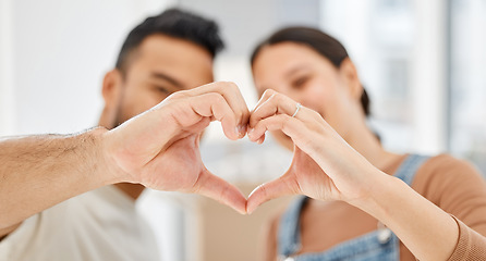 Image showing I cant wait to raise a family with you in this loving home. Closeup shot of a couple making a heart shape with their hands while moving house.