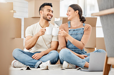 Image showing Cheers to us making this all come true. a young couple sitting on the floor and drinking coffee while moving house.