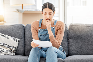 Image showing I dont have a plan B...a young woman anxiously biting her nails and reading a letter while moving house.