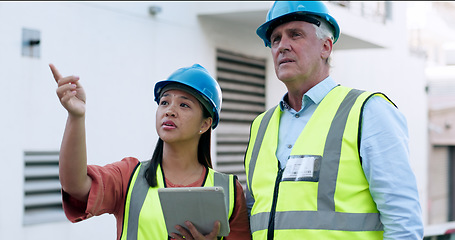 Image showing Construction, team and tablet for inspection with people at job site, mentor and apprentice with communication. Architecture, engineering and digital floor plan, old man and woman outdoor in meeting