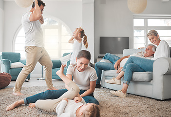 Image showing Families are hidden treasures. a young family playing together in the lounge at home.