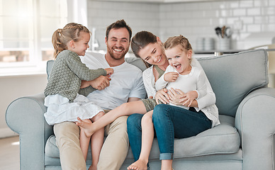 Image showing Nothings more important than family. a young family playing together on a sofa at home.