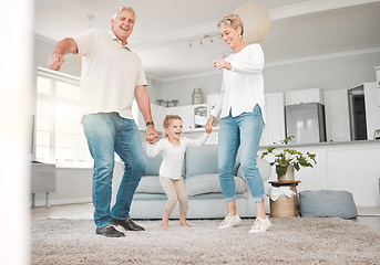Image showing Go home and love your family. an adorable little girl bonding with her grandparents while dancing with them in the living room.