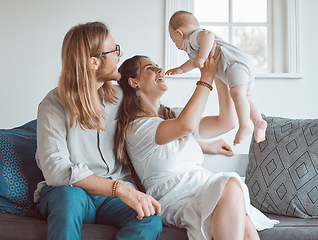 Image showing Weve got more than we need. a young family bonding with their baby boy at home.