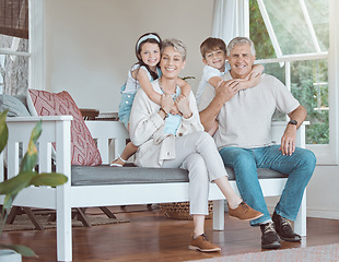 Image showing Let love be your energy. grandparents bonding with their grandkids on the sofa at home.