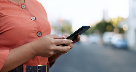 Image showing Hands typing, smartphone and woman in city on social media, internet search or communication. Closeup, phone or person scroll on digital technology, notification or writing email on mobile app online