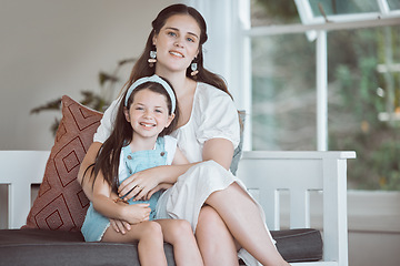 Image showing Hope is frail, teach her strength. an adorable little girl relaxing with her mother on the sofa at home.