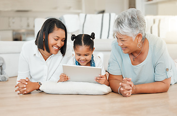 Image showing The most important thing in the world is family. a young family happily bonding while using a digital tablet at home.