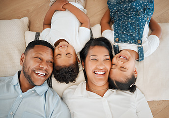 Image showing In family life, love is the oil that eases friction. a family laying on the floor at home.