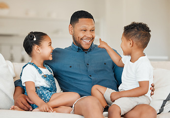 Image showing Keep showing how much you love and appreciate your family. a young father sitting on the sofa at home with his children.