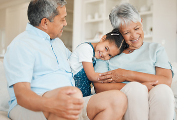 Image showing The family is the test of freedom. grandparents bonding with their granddaughter on a sofa at home.