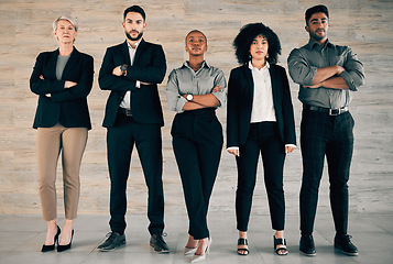 Image showing Start by doing what’s necessary. a group of businesspeople standing with their arms crossed in an office at work.