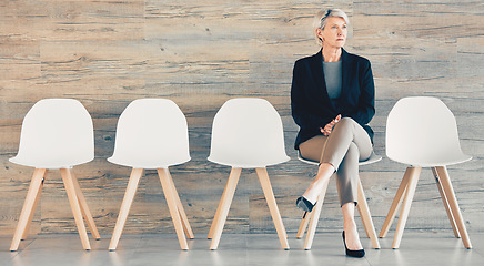 Image showing Do the little jobs well. a young businesswoman waiting in line at an office.