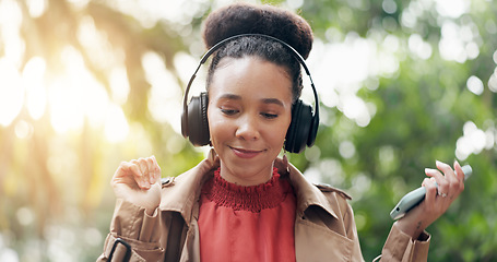 Image showing Happy woman, phone and headphones in nature for music, audio streaming or outdoor sound track. Female person smile with technology on smartphone listening to podcast, playlist or songs at park