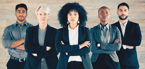 Image showing Learn from the mistakes of others. a group of businesspeople standing with their arms crossed in an office at work.