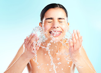 Image showing Be good to your skin. a young woman doing her daily skincare routine against a blue background.