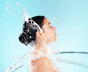 Image showing Life is short. Buy the serum. a beautiful young woman being splashed with water against a blue background.
