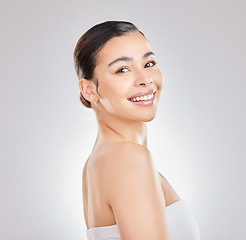 Image showing Show off that smile. a young woman posing against a grey background.
