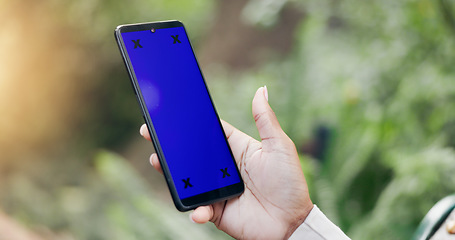 Image showing Woman, phone and hands with blue screen for marketing, advertising or app in outdoor nature. Closeup of female person with mobile smartphone display with chromakey or tracking markers on mockup space