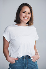 Image showing Carry yourself with a smile. a beautiful young woman posing against a grey background.