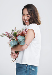 Image showing I dont like flowers, I adore them. a beautiful young woman posing with a bouquet against a white background.