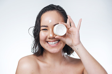 Image showing This will help your skin look flawless for many years to come. a beautiful young woman holding up a pot of moisturiser.