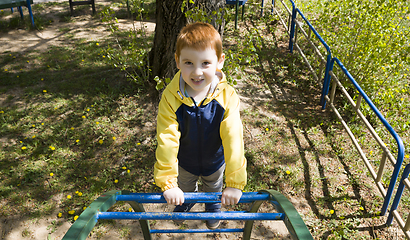 Image showing boy climbing ladder