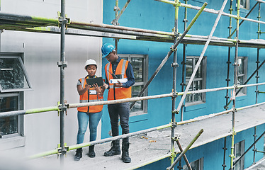 Image showing Adopting technology to ramp up the development on a new site. a young man and woman using a digital tablet while working at a construction site.