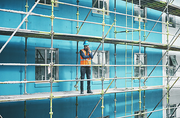 Image showing Engineers simple love solving problems. a young man talking on a cellphone while working at a construction site.