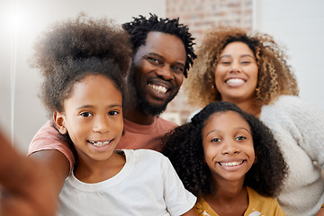 Image showing Smiling together, staying together. a young family taking a selfie at home.