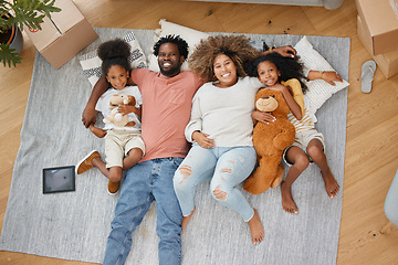 Image showing Forming family bonds. Aerial shot of a young family lying on the floor at home.