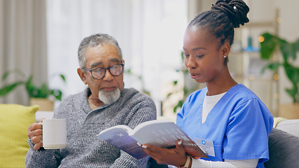 Image showing Coffee, reading book or senior man with nurse on sofa for nursing home, retirement or house. Healthcare, help or elderly patient with caregiver, black woman or volunteer in hospice for rehabilitation
