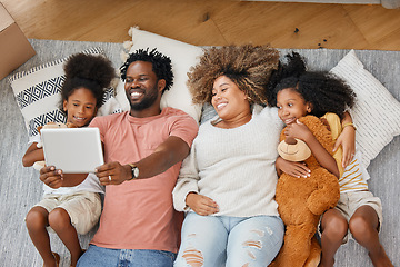Image showing Weekends are for spending time with family. a young family spending time together and using a digital tablet at home.