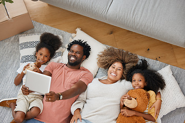 Image showing Love is the glue that keeps our family together. a young family spending time together and using a digital tablet at home.