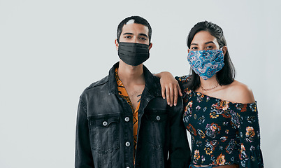 Image showing In uncertain times having someone to lean on is invaluable. Studio shot of a masked young man and woman posing against a grey background.