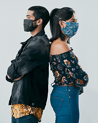 Image showing Stand firm in the face of a crisis. Studio shot of a masked young man and woman posing against a grey background.