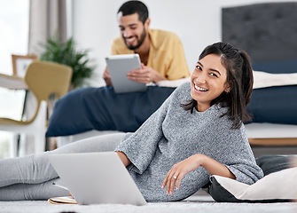 Image showing Good connectivity makes our quarantine an entertaining one. a young couple using their wireless devices in bed.