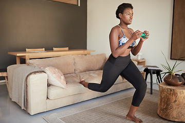 Image showing Lunging in the lounge. a young woman exercising at home.