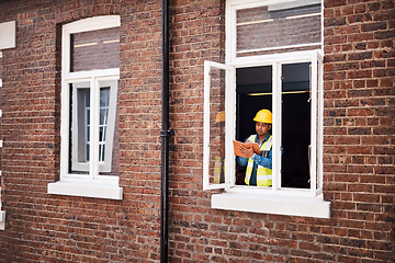 Image showing I have so many ideas for this building. a engineer making notes while on a construction site.