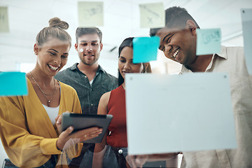 Image showing A little inspiration can kickoff a whole lot more. a group of businesspeople using a digital tablet while brainstorming with notes on a glass wall in an office.