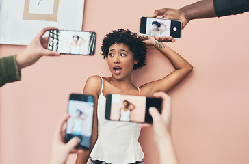 Image showing Im always up for a social media photo. a beautiful young woman having her picture taken on multiple phones.