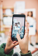 Image showing Lets start a trend. two young women posing with a social media prop while having their picture taking on a smartphone.