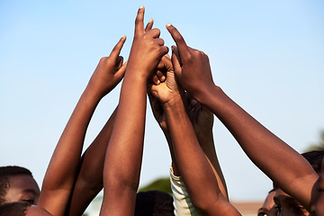 Image showing Coming together as champions. Closeup shot of a group of young boys joining their hands together in a huddle.